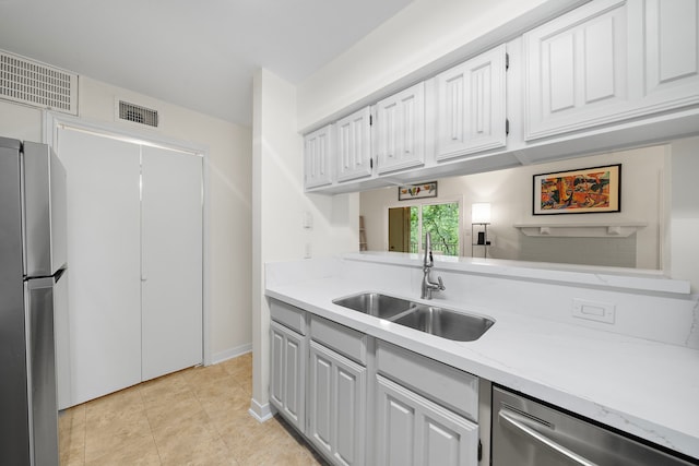 3500 Tangle Brush Dr Unit 28, The Woodlands, TX 77381 - kitchen featuring appliances with stainless steel finishes, light countertops, white cabinetry, and light tile patterned floors