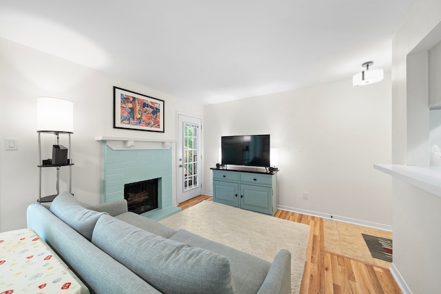 3500 Tangle Brush Dr Unit 28, The Woodlands, TX 77381 - living area with a fireplace and light wood-style flooring