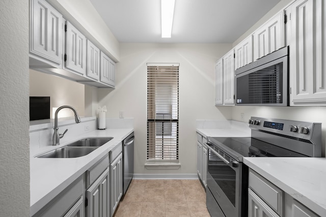 3500 Tangle Brush Dr Unit 28, The Woodlands, TX 77381 - kitchen with appliances with stainless steel finishes, gray cabinets, light countertops, and light tile patterned flooring