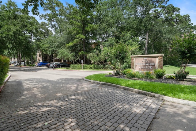 3500 Tangle Brush Dr Unit 28, The Woodlands, TX 77381 - view of decorative road featuring curbs and view of wooded area