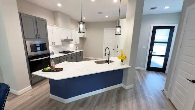 4307B Dickson St, Houston, TX 77007 - kitchen featuring appliances with stainless steel finishes, a peninsula, tasteful backsplash, light wood finished floors, and recessed lighting