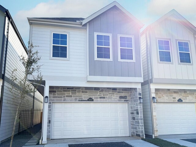 4307B Dickson St, Houston, TX 77007 - view of front of home featuring stone siding, a garage, and board and batten siding