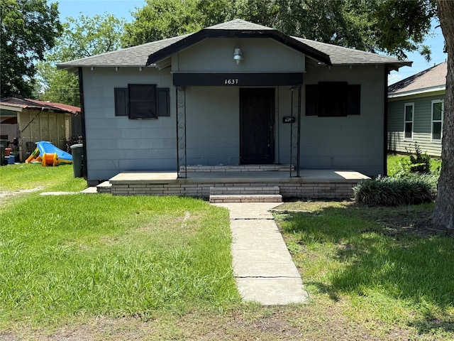 1637 15th St, Port Arthur, TX 77640 - bungalow-style house with a front lawn, roof with shingles, and covered porch