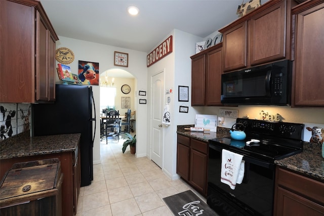 25106 Dickens Dr, Magnolia, TX 77355 - kitchen featuring black appliances, light tile patterned flooring, arched walkways, dark stone counters, and recessed lighting