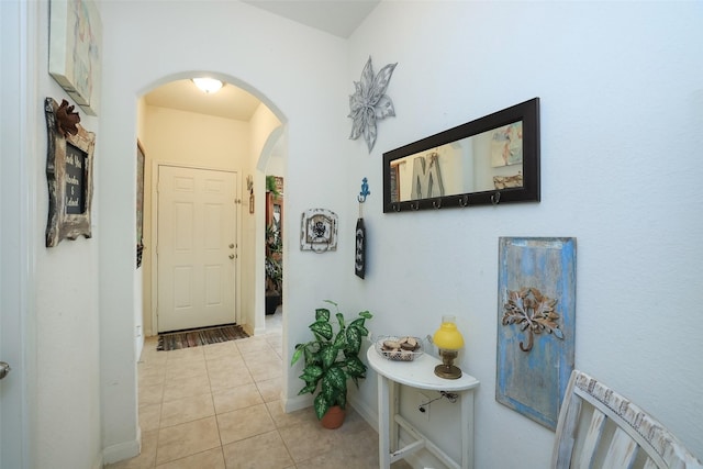 25106 Dickens Dr, Magnolia, TX 77355 - hall featuring arched walkways and light tile patterned floors