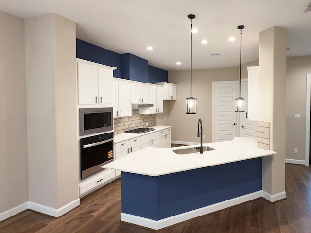 1438B Dian St, Houston, TX 77008 - kitchen featuring oven, stainless steel microwave, a peninsula, tasteful backsplash, and white cabinetry