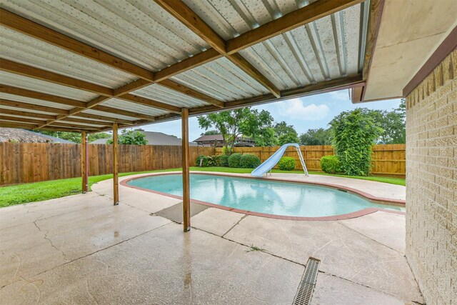 3313 Park Dale Dr, Deer Park, TX 77536 - view of swimming pool with a water slide, a patio, and a fenced backyard