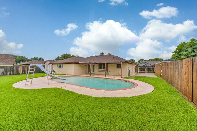 3313 Park Dale Dr, Deer Park, TX 77536 - view of swimming pool with a water slide, a fenced backyard, and a patio area