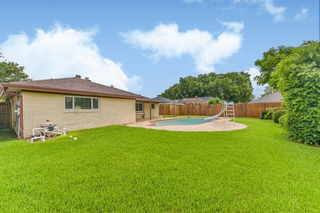 3313 Park Dale Dr, Deer Park, TX 77536 - rear view of house featuring a fenced backyard, brick siding, and a patio area