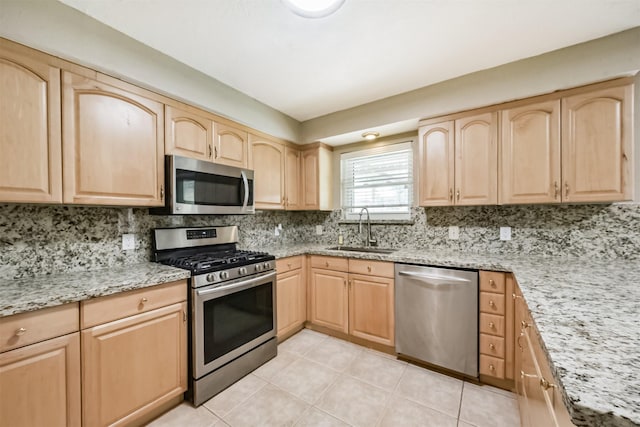 3313 Park Dale Dr, Deer Park, TX 77536 - kitchen with appliances with stainless steel finishes, light brown cabinetry, light stone countertops, light tile patterned floors, and backsplash
