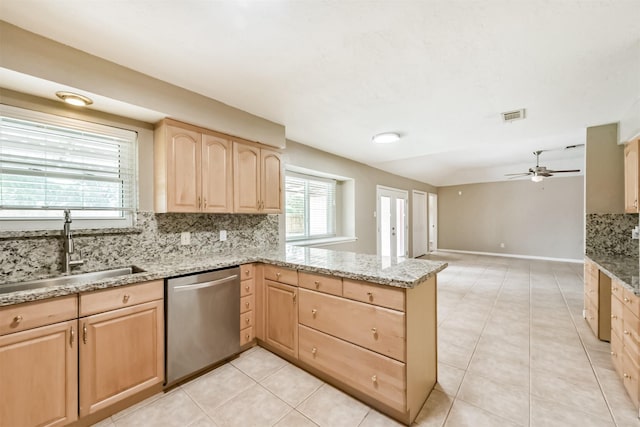 3313 Park Dale Dr, Deer Park, TX 77536 - kitchen featuring light brown cabinets, stainless steel dishwasher, a peninsula, ceiling fan, and backsplash