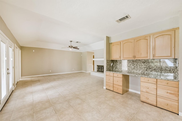 3313 Park Dale Dr, Deer Park, TX 77536 - kitchen with light brown cabinets, tasteful backsplash, built in desk, light tile patterned floors, and a ceiling fan