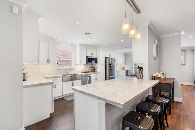 1011 Martin St, Houston, TX 77018 - kitchen featuring appliances with stainless steel finishes, backsplash, plenty of natural light, white cabinets, and crown molding