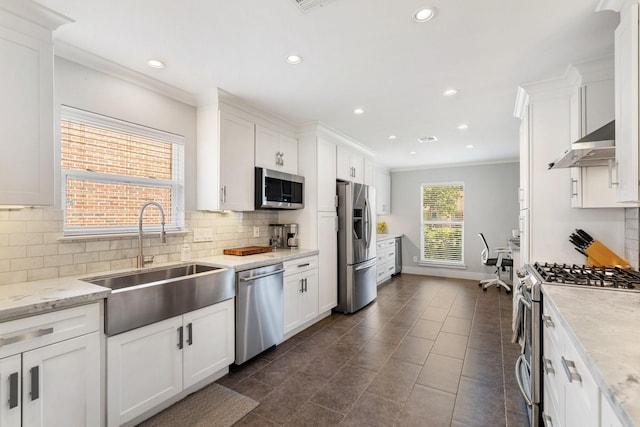 1011 Martin St, Houston, TX 77018 - kitchen with appliances with stainless steel finishes, ventilation hood, white cabinetry, decorative backsplash, and crown molding
