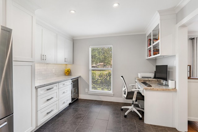 1011 Martin St, Houston, TX 77018 - office area featuring built in desk, beverage cooler, ornamental molding, recessed lighting, and dark tile patterned floors