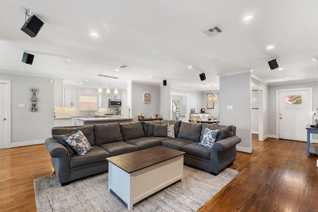 1011 Martin St, Houston, TX 77018 - living room with crown molding, recessed lighting, light wood-style floors, and a chandelier