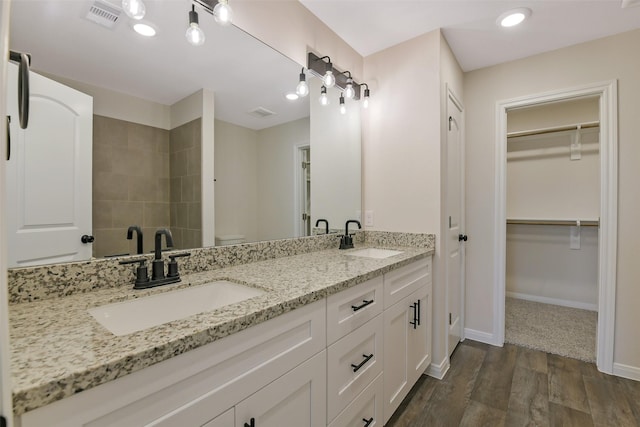 405 3rd St, Hempstead, TX 77445 - bathroom with double vanity, wood finished floors, and a walk in closet