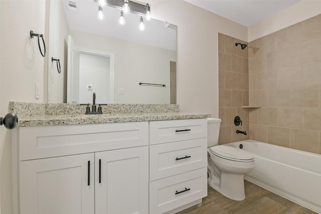 405 3rd St, Hempstead, TX 77445 - bathroom with wood finished floors, vanity, and washtub / shower combination