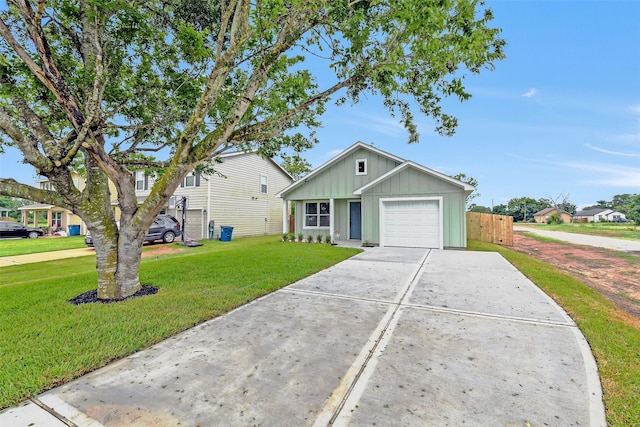 405 3rd St, Hempstead, TX 77445 - view of front facade featuring board and batten siding, a garage, and concrete driveway