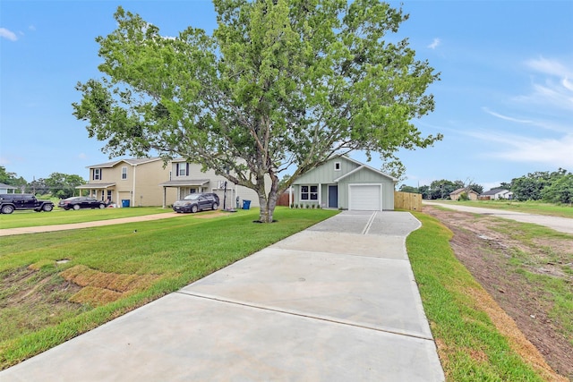 405 3rd St, Hempstead, TX 77445 - view of front of home featuring a front yard, driveway, a garage, and board and batten siding