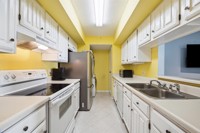 4001 E Nasa Rd Unit 118, Seabrook, TX 77586 - kitchen with white appliances, under cabinet range hood, white cabinets, and light countertops