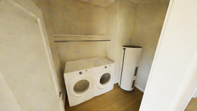 212 Kyle St, Madisonville, TX 77864 - laundry room with washing machine and clothes dryer and wood finished floors