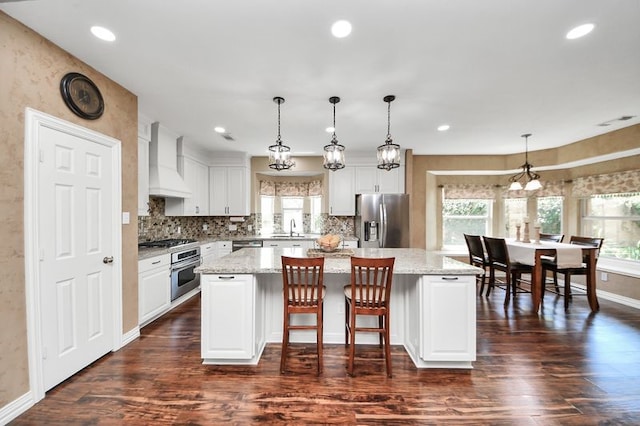 30103 Canyon Branch Ct, Spring, TX 77386 - kitchen featuring stainless steel appliances, wall chimney exhaust hood, plenty of natural light, dark wood-style floors, and recessed lighting