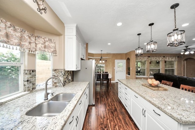 30103 Canyon Branch Ct, Spring, TX 77386 - kitchen featuring a chandelier, dark wood-style floors, recessed lighting, a center island, and white cabinetry