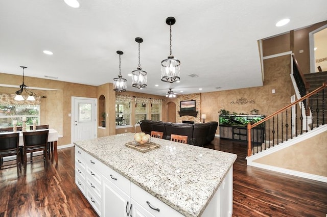 30103 Canyon Branch Ct, Spring, TX 77386 - kitchen featuring dark wood-type flooring, light stone countertops, recessed lighting, hanging light fixtures, and a kitchen island