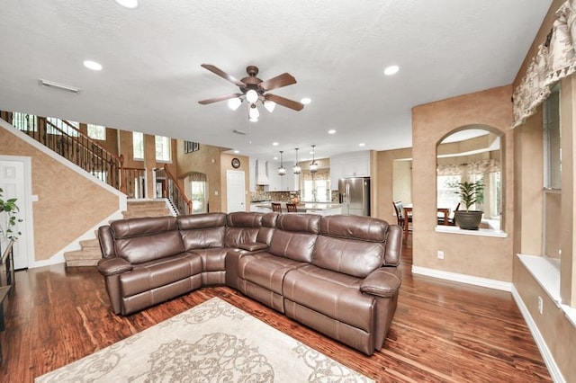 30103 Canyon Branch Ct, Spring, TX 77386 - living area with wood finished floors, ceiling fan, recessed lighting, stairs, and arched walkways