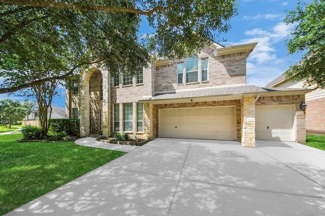 30103 Canyon Branch Ct, Spring, TX 77386 - traditional-style house featuring driveway, a front yard, stone siding, and an attached garage