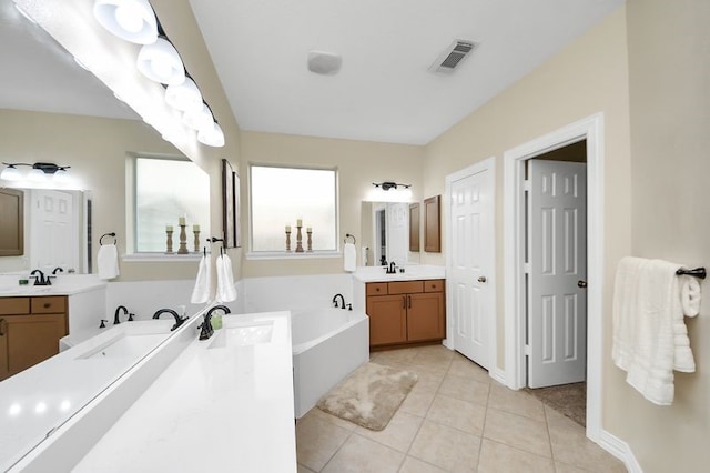 30103 Canyon Branch Ct, Spring, TX 77386 - full bath with tile patterned floors, two vanities, and a garden tub