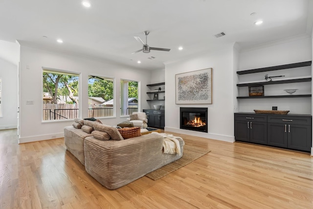 5216 Chestnut St, Bellaire, TX 77401 - living room with ceiling fan, light wood-type flooring, a glass covered fireplace, recessed lighting, and ornamental molding