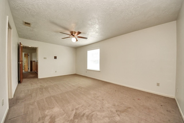 3515 Kansas St, Fresno, TX 77545 - empty room featuring ceiling fan, a textured ceiling, light carpet, and attic access