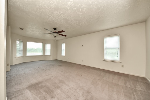 3515 Kansas St, Fresno, TX 77545 - carpeted empty room featuring plenty of natural light, ceiling fan, and a textured ceiling