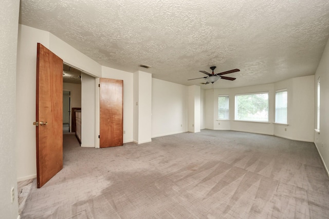 3515 Kansas St, Fresno, TX 77545 - spare room featuring ceiling fan, light carpet, and a textured ceiling