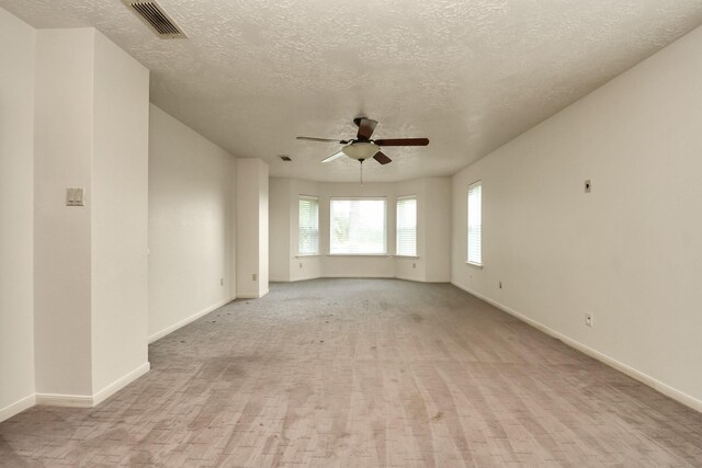 3515 Kansas St, Fresno, TX 77545 - empty room featuring ceiling fan, a textured ceiling, and light colored carpet