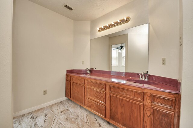 3515 Kansas St, Fresno, TX 77545 - full bathroom featuring marble look tile flooring, double vanity, and a textured ceiling