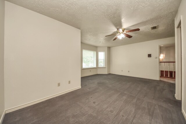 3515 Kansas St, Fresno, TX 77545 - unfurnished room featuring ceiling fan, a textured ceiling, and dark carpet