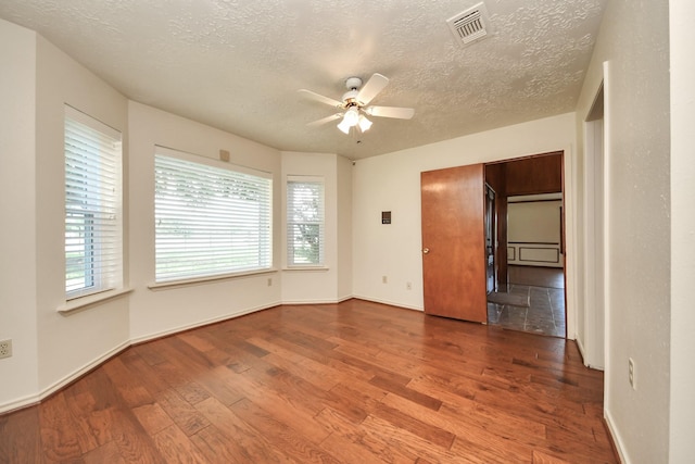 3515 Kansas St, Fresno, TX 77545 - spare room featuring wood finished floors, a ceiling fan, a textured ceiling, and plenty of natural light