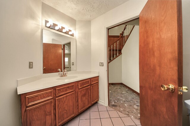 3515 Kansas St, Fresno, TX 77545 - bathroom with vanity, a textured ceiling, and tile patterned floors