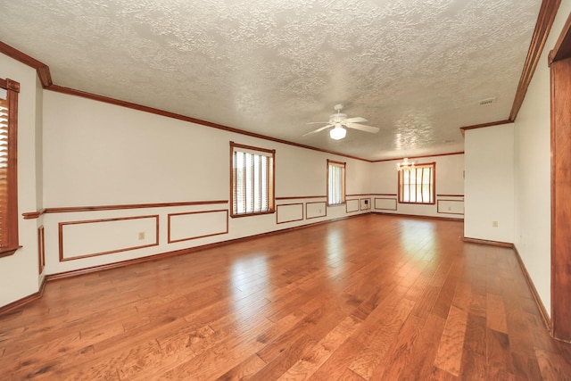 3515 Kansas St, Fresno, TX 77545 - empty room with ceiling fan, hardwood / wood-style floors, plenty of natural light, a textured ceiling, and ornamental molding