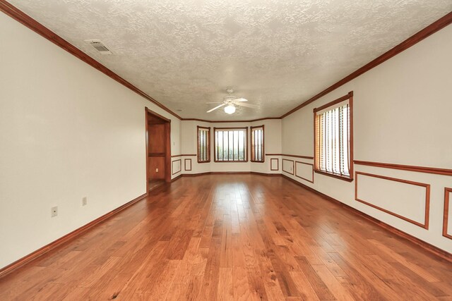 3515 Kansas St, Fresno, TX 77545 - spare room with ceiling fan, wood-type flooring, a textured ceiling, and crown molding