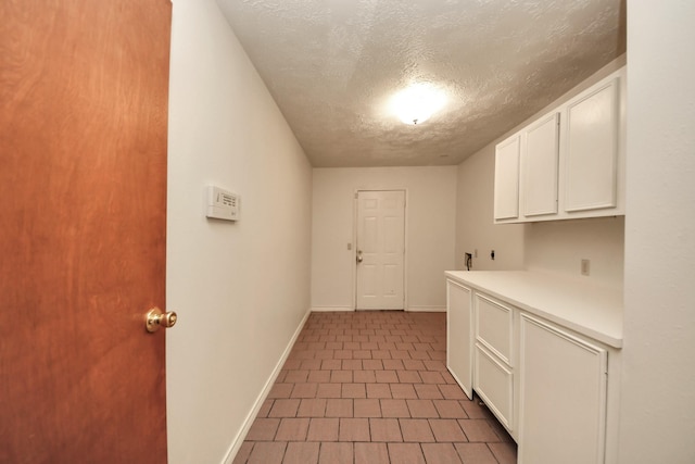3515 Kansas St, Fresno, TX 77545 - washroom with cabinet space, a textured ceiling, hookup for a washing machine, tile patterned flooring, and electric dryer hookup
