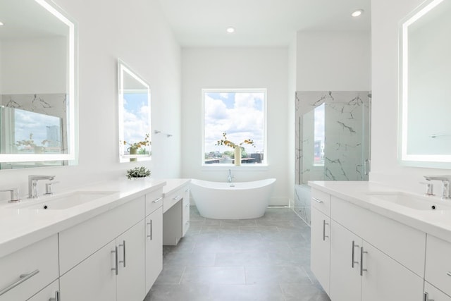 5302 S Capitol, Houston, TX 77023 - bathroom with two vanities, a marble finish shower, a soaking tub, recessed lighting, and tile patterned flooring