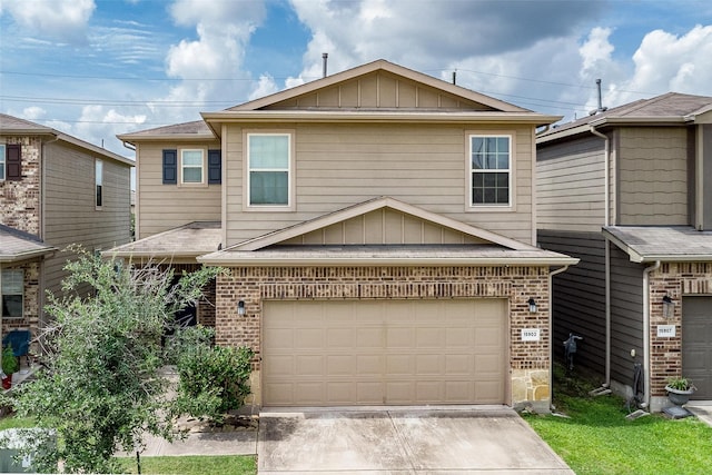 15903 Smithland Dr, Houston, TX 77084 - view of front of house with brick siding, board and batten siding, concrete driveway, and a garage