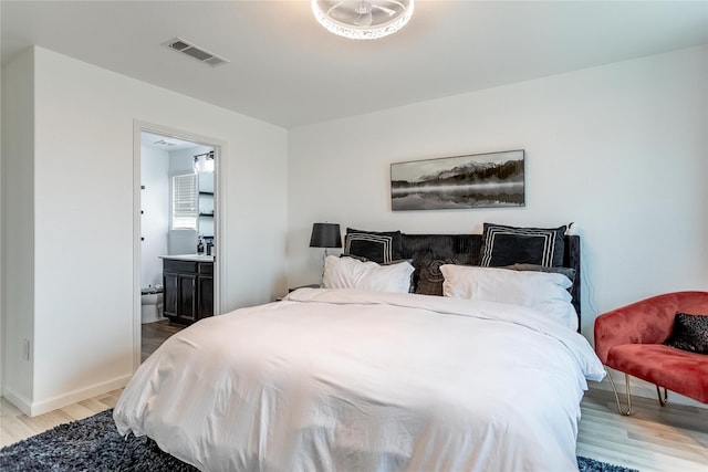 15903 Smithland Dr, Houston, TX 77084 - bedroom with light wood-type flooring and connected bathroom