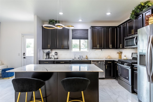 15903 Smithland Dr, Houston, TX 77084 - kitchen with appliances with stainless steel finishes, a kitchen bar, light stone counters, and recessed lighting