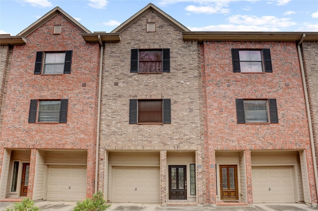 2904 Chenevert St Unit J, Houston, TX 77004 - view of front of home featuring a garage, driveway, and brick siding