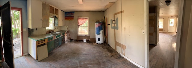107 Russell St, Liberty Hill, TX 78642 - kitchen featuring water heater, wood finished floors, and light countertops